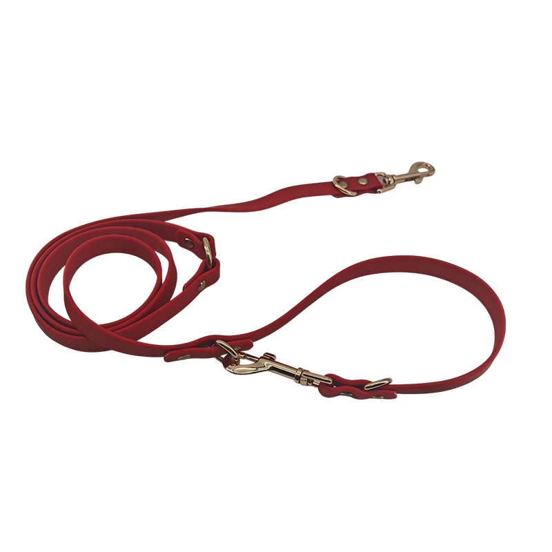 red PVC double-ended dog leash with two metal snap hooks and a reinforced strap, on a white background.