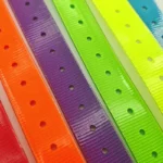 multicolor TPU dog collar with TPU-coated strap, adjustment holes, and metal buckle, in a multicolor product assortment.