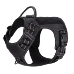 black tactical dog harness with adjustable straps, padded chest panel, and metal D-rings, on a white background.