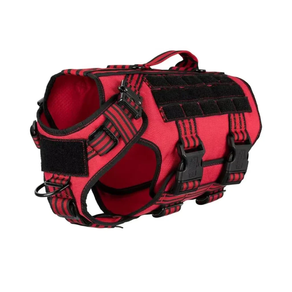 red tactical Molle dog harness with black webbing, adjustable straps, and metal D-rings, on a white background.