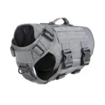 light gray tactical Molle dog harness with black webbing, adjustable straps, and metal D-rings, on a white background.